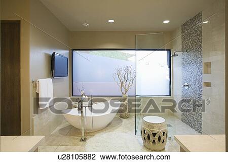 Stock Image - Palm Springs bathroom with freestanding bath. Fotosearch