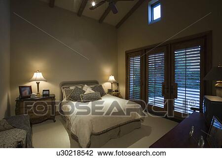 Stock Image - Palm Springs bedroom at dusk. Fotosearch