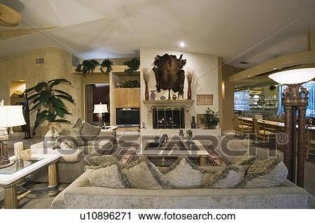 Stock Image - palm Springs living room with wall-mounted animal pelt. Fotosearch