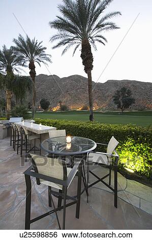 Stock Photograph - Patio chairs and tables in Palm Springs. Fotosearch