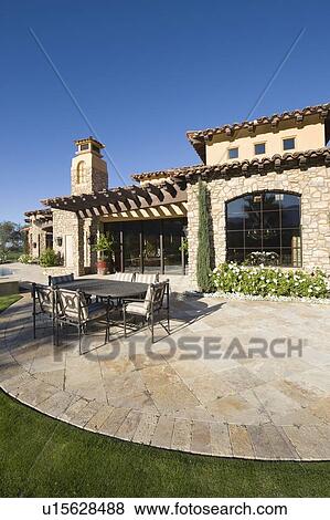 Stock Photo - Paved dining area of Palm Springs hacienda. Fotosearch