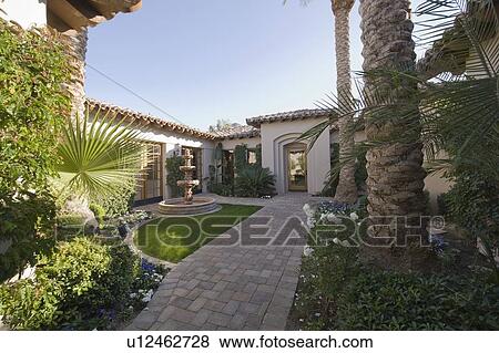 Paved path and water fountain in Palm Springs garden exterior View Large Photo Image Stock Photo - Paved path and water fountain in Palm Springs garden exterior. Fotosearch