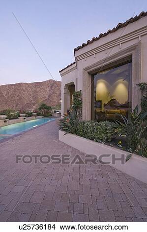 Paved poolside area and window exteriors of Palm Springs home View Large Photo Image Picture - Paved poolside area and window exteriors of Palm Springs home. Fotosearch