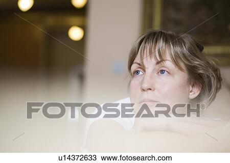 Stock Image - Pensive mature woman close-up view selective focus portrait. Fotosearch