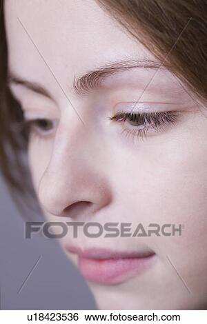 Stock Photograph - Pensive young woman close-up . Fotosearch