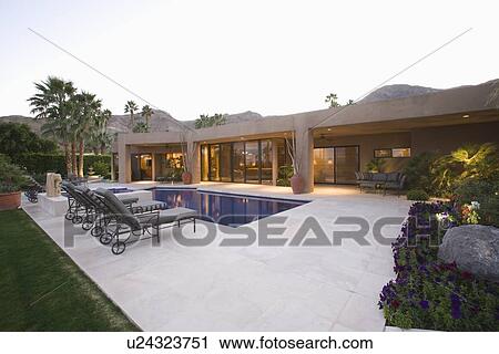 Poolside area with sun loungers Palm Springs home View Large Photo Image Stock Image - Poolside area with sun loungers Palm Springs home. Fotosearch