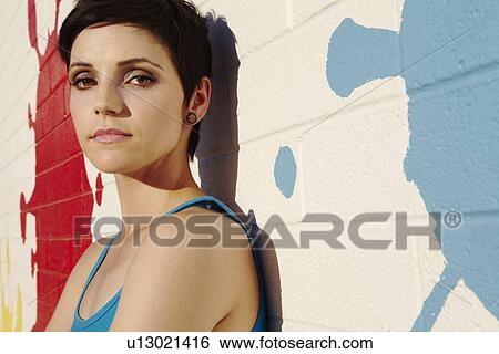 Stock Photograph - Portrait of fashionable impish young woman. Fotosearch