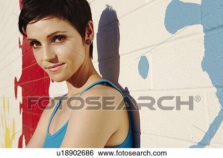 Stock Photograph - Portrait of fashionable impish young woman. Fotosearch