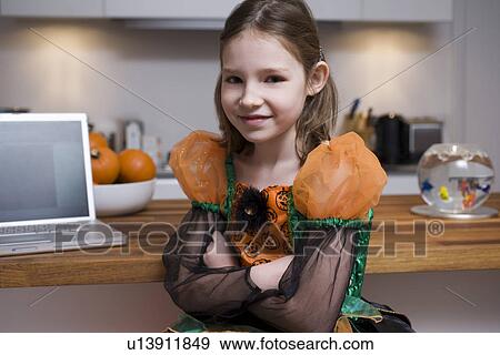 Portrait of girl by laptop in home View Large Photo Image Stock Photo - Portrait of girl by laptop in home. Fotosearch