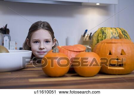 Portrait of girl with pumpkins in home View Large Photo Image Stock Image - Portrait of girl with pumpkins in home. Fotosearch