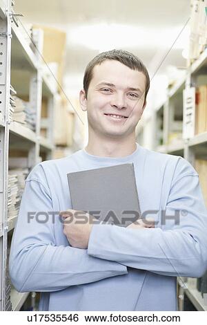 Stock Photograph - Portrait of man holding a book. Fotosearch
