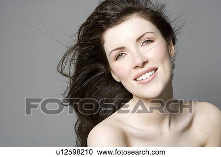 Stock Image - Portrait of woman with brown hair. Fotosearch