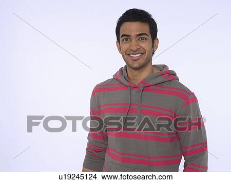 Portrait of young (20-25 years) man smiling studio shot View Large Photo Image Picture - Portrait of young (20-25 years) man smiling studio shot. Fotosearch