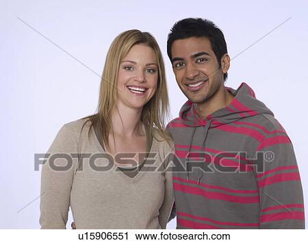 Stock Image - Portrait of young man and woman studio shot. Fotosearch