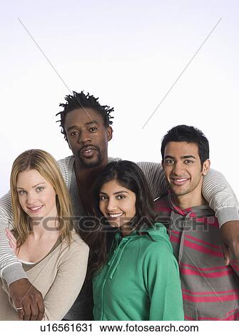 Stock Image - Portrait of young people embracing studio shot. Fotosearch