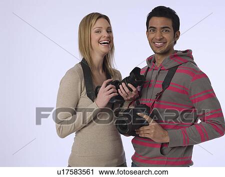 Portrait of young photographers with cameras studio shot View Large Photo Image Stock Image - Portrait of young photographers with cameras studio shot. Fotosearch