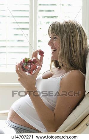 Pregnant woman eating strawberries View Large Photo Image Stock Image - Pregnant woman eating strawberries. Fotosearch
