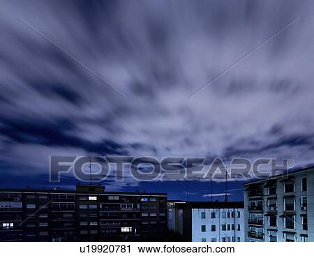 Stock Image - Quickening sky over city buildings. Fotosearch