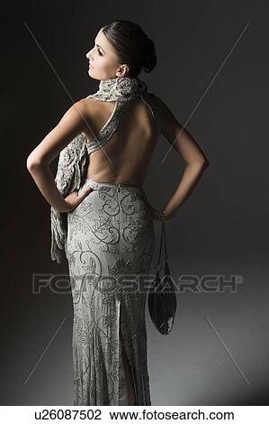 Rear view of woman in backless dress View Large Photo Image Stock Image - Rear view of woman in backless dress. Fotosearch