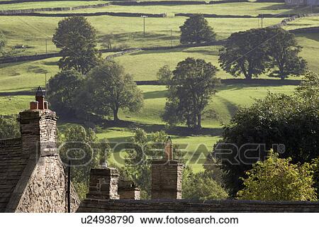 Roofs of houses and trees on fields in Yorkshire Dales Yorkshire England View Large Photo Image Stock Image - Roofs of houses and trees on fields in Yorkshire Dales Yorkshire England. Fotosearch