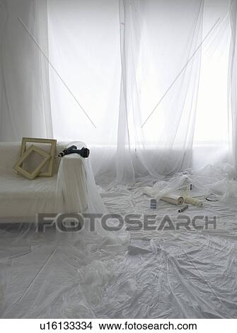 Room covered in transparent dust sheets in preparation for decorating View Large Photo Image Picture - Room covered in transparent dust sheets in preparation for decorating. Fotosearch