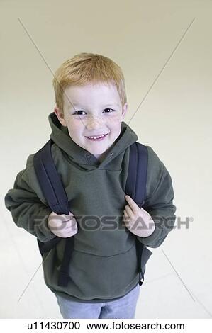 Schoolboy with redhair and freckles stands with backpack View Large Photo Image Stock Image - Schoolboy with redhair and freckles stands with backpack. Fotosearch