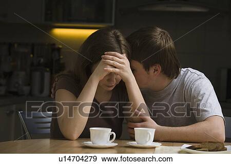 Serious young couple woman with head in hands View Large Photo Image Stock Photo - Serious young couple woman with head in hands. Fotosearch