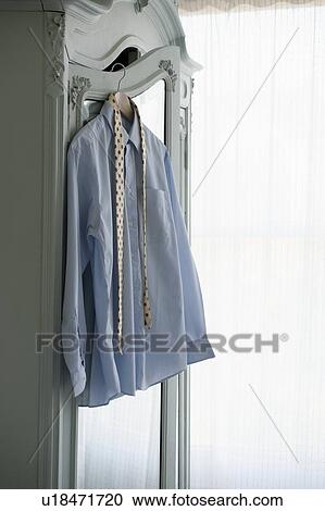 Shirt and tie hang on wardrobe View Large Photo Image Stock Image - Shirt and tie hang on wardrobe. Fotosearch