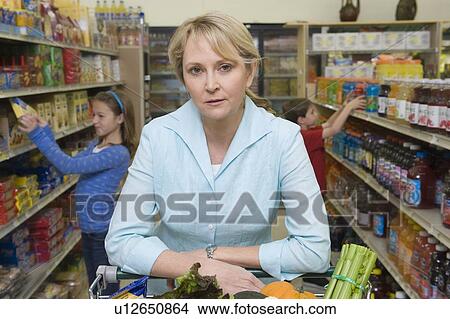 Single mother shopping with son and daughter View Large Photo Image Picture - Single mother shopping with son and daughter. Fotosearch