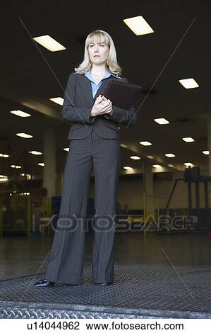 Smartly dressed woman working in newspaper factory View Large Photo Image Stock Image - Smartly dressed woman working in newspaper factory. Fotosearch