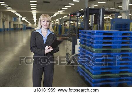 Stock Photo - Smartly dressed woman working in newspaper factory. Fotosearch
