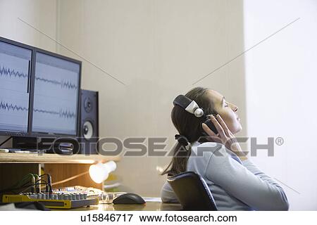 Stock Photo - Sound engineer listening to music. Fotosearch