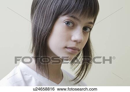 Stock Photograph - Studio portrait of girl with brown hair. Fotosearch