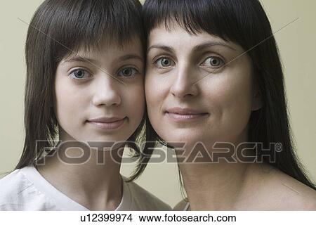 Studio portrait of mother and daughter smiling View Large Photo Image Picture - Studio portrait of mother and daughter smiling. Fotosearch