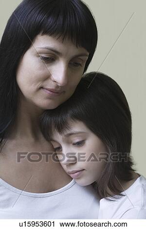 Stock Image - Studio portrait of mother and daughter. Fotosearch