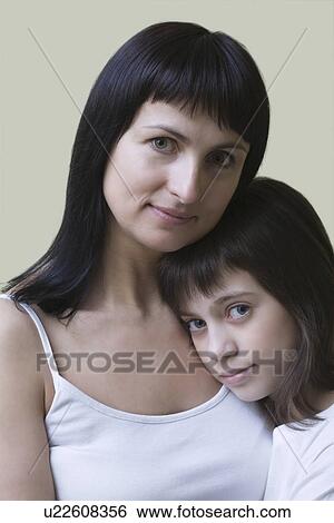 Stock Photograph - Studio portrait of mother and daughter. Fotosearch