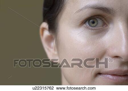 Stock Image - Studio portrait of womans face. Fotosearch