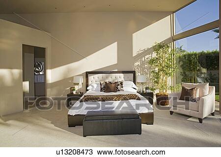 Stock Image - Sunlit Palm Springs bedroom. Fotosearch