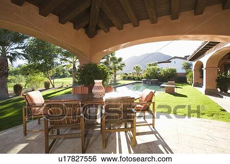 Stock Photograph - Sunlit veranda of Palm Springs hacienda. Fotosearch
