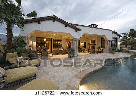 Sunloungers on poolside area of Palm Springs home View Large Photo Image Stock Image - Sunloungers on poolside area of Palm Springs home. Fotosearch