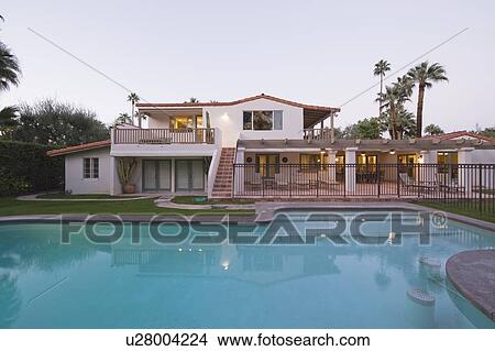 Picture - Swimming pool and lit exterior of Palm Springs home exterior. Fotosearch