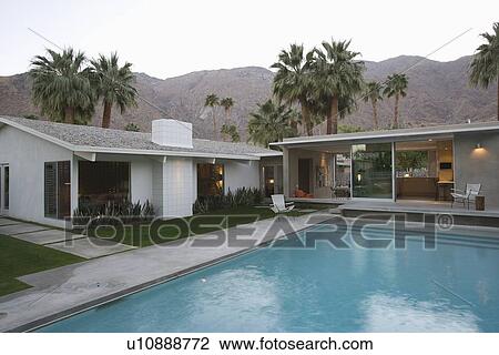 Swimming pool and palm trees Palm Springs home View Large Photo Image Stock Image - Swimming pool and palm trees Palm Springs home. Fotosearch