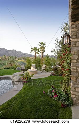 Stock Photo - Swimming pool by luxurious residence. Fotosearch