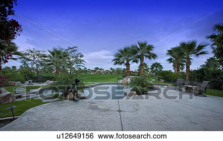 Swimming pool in backyard of luxury home View Large Photo Image Stock Photograph - Swimming pool in backyard of luxury home. Fotosearch