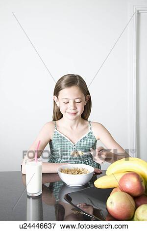 Teen girl having breakfast View Large Photo Image Stock Photo - Teen girl having breakfast. Fotosearch