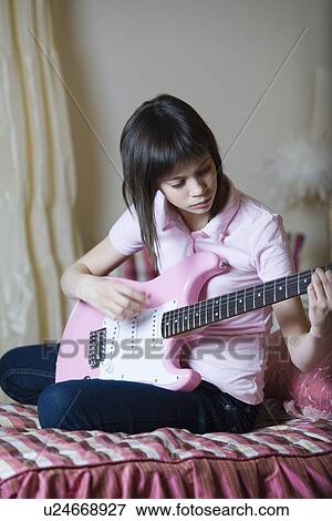 Teenage girl playing electric guitar View Large Photo Image Stock Photo - Teenage girl playing electric guitar. Fotosearch