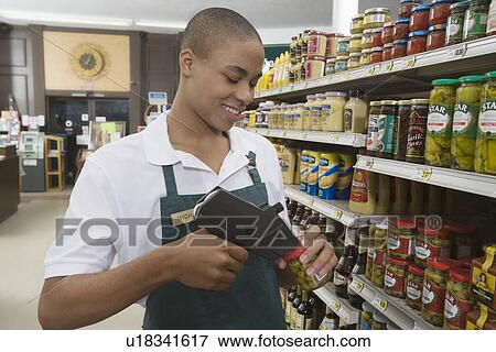 Teenage supermarket employee View Large Photo Image Stock Photo - Teenage supermarket employee. Fotosearch