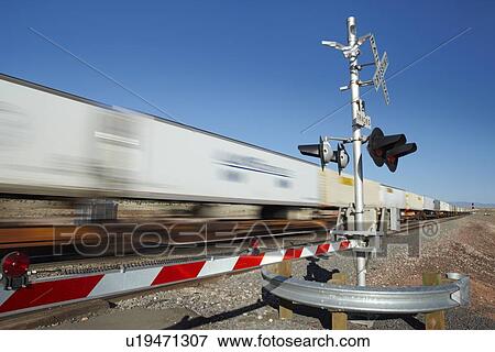 Train passing level crossing motion blur View Large Photo Image Stock Photo - Train passing level crossing motion blur. Fotosearch