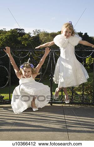 Stock Image - Two girl bridesmaids waiting for wedding ceremony. Fotosearch