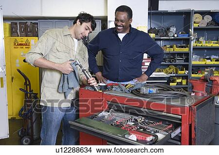 Two men in workshop with tools View Large Photo Image Picture - Two men in workshop with tools. Fotosearch